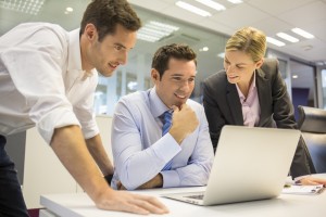 A business team of three in office and planning work